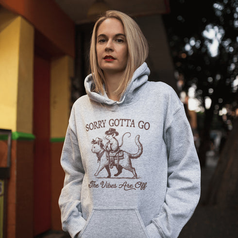 Take your fashion game to the wild frontier with our quirky and bold hoodie featuring a mouse riding a cat like a cowboy—both decked out in classic cowboy hats.